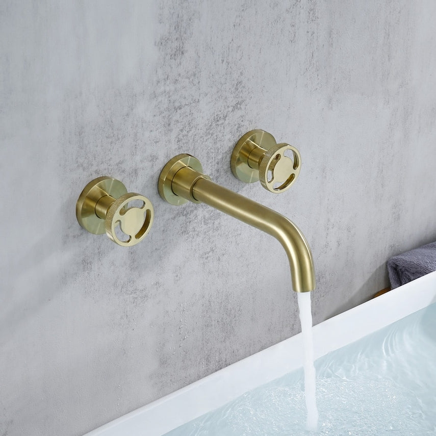 The Morsale.com Dual-Handle Wall-Mount Brass Faucet, featuring matching round handles, delivers a sleek stream above the bathtub and enhances any bathroom with contemporary elegance against a light gray textured wall.