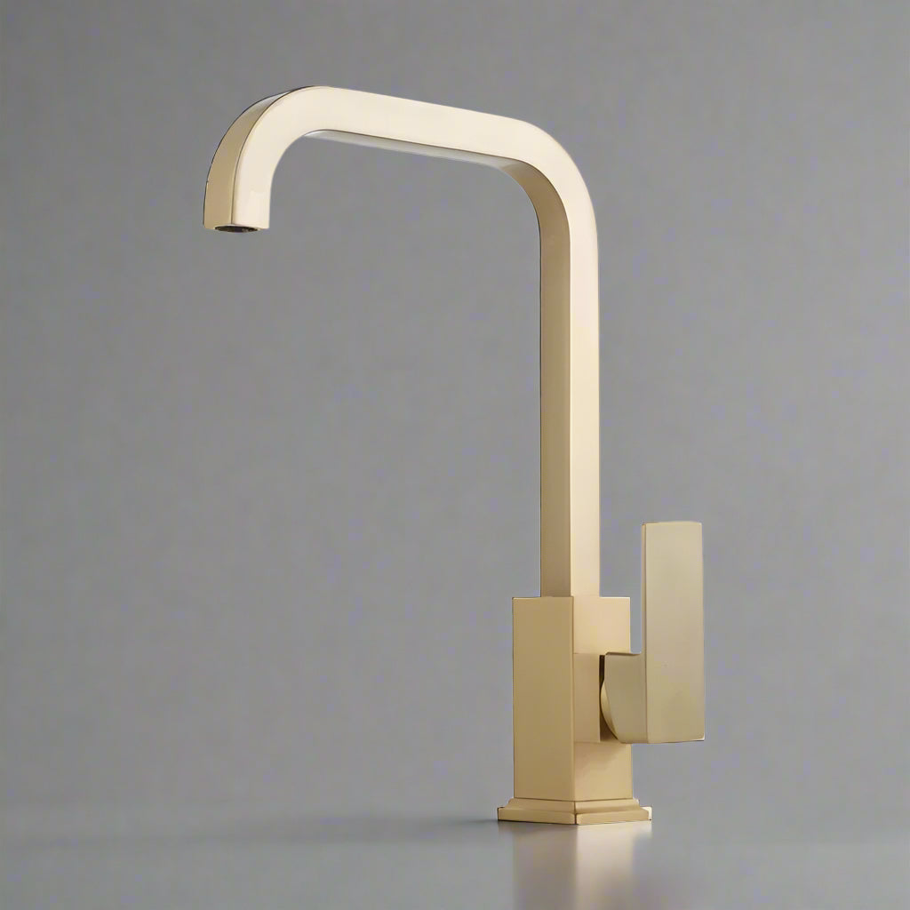 The Tiqui™ Solid Brass Single Handle Kitchen Faucet by Tiqui features a modern gold finish, a square base, and a sleek single lever handle, showcased against a simple gray background.