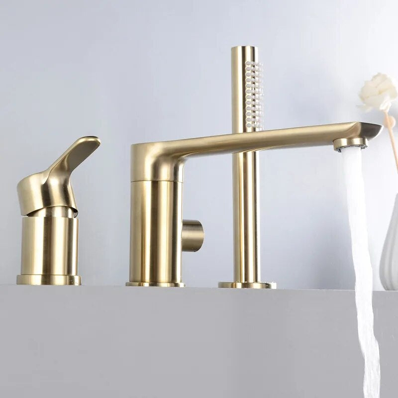 Tiqui's Solid Brass Shower Set with Bathtub Faucet boasts a modern gold finish and a sleek design. It features a cylindrical handle mounted on the side and includes a separate soap dispenser. Water flows smoothly in a fan-like stream from the spout, complementing its installation on a light-colored countertop.