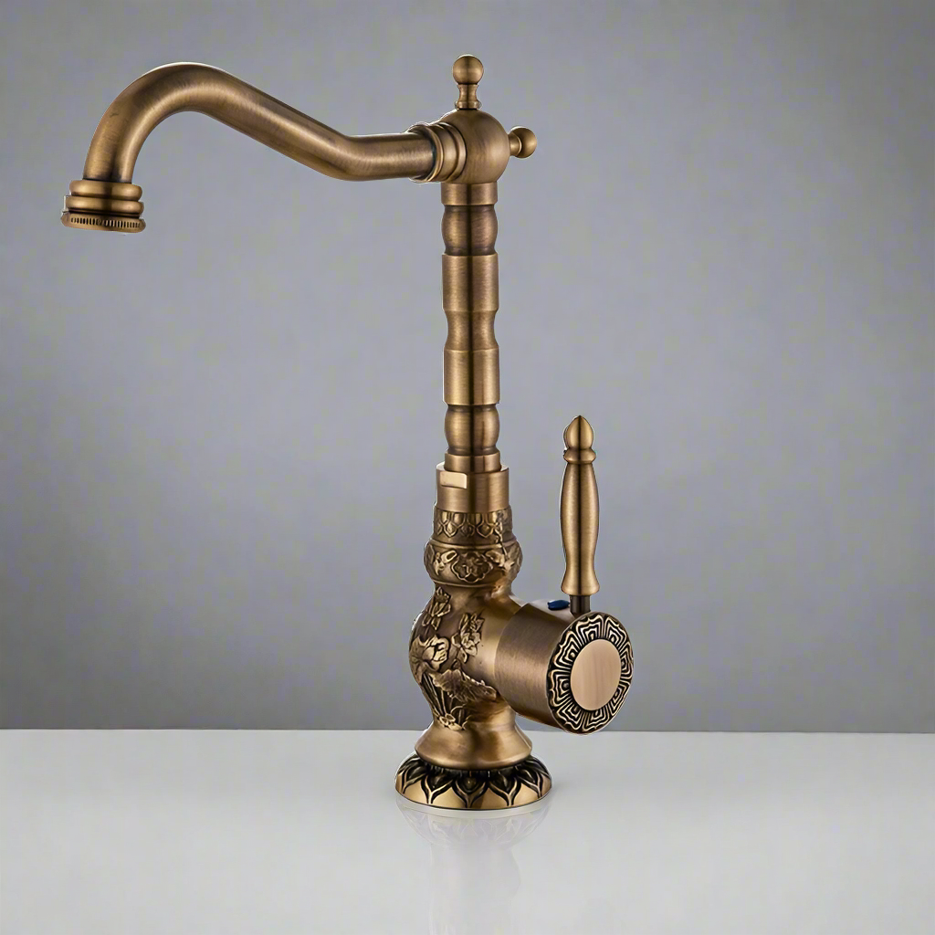 The Rozin Antique Brass Single Handle Faucet features ornate detailing, a curved spout, and a single lever handle, showcased against a plain gray background on a white surface.