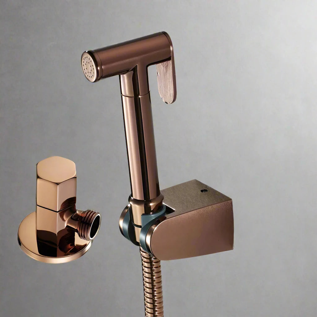 The Tiqui Windsor Brushed Gold Bidet Sprayer Kit, shown on a plain gray background, features a metallic handheld design with wall mount and valve. Its brushed gold finish adds elegance and function to any bathroom.