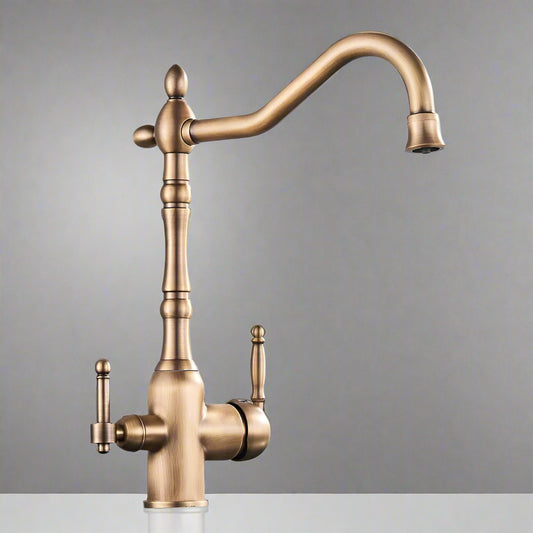 The Uythner Antique Brass Kitchen Faucet With Filtered Water Tap features a vintage design, two handles, and a high curved spout, displayed against a plain gray background.
