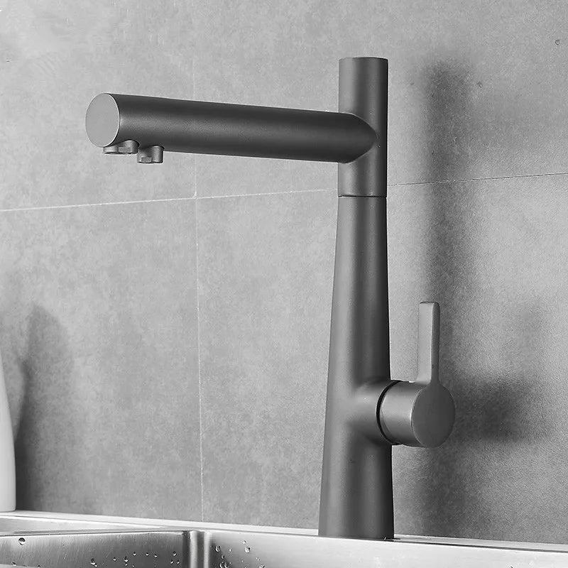 In this chic modern kitchen, an Allfixture Kitchen Faucet With Purified Water Tap, featuring a sleek design and a matte black finish, is mounted over a stainless steel sink against a gray tiled backsplash. Purified water flows smoothly from the faucet, and a white bottle is partially visible on the left.