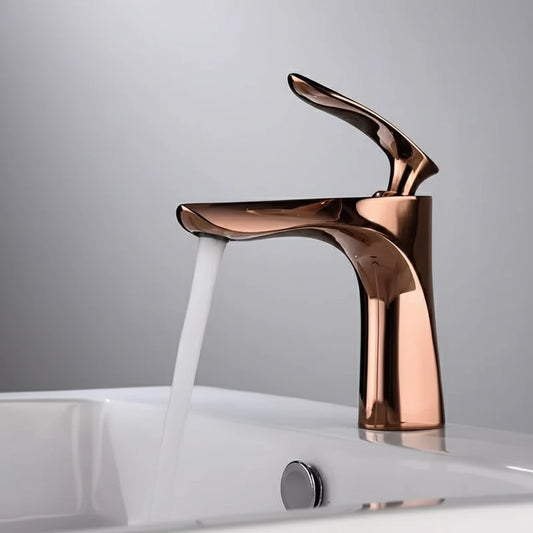 The Allfixture Valmont Rose Gold Bathroom Faucet, featuring a sleek single-handle design, releases a stream of water into a white sink, set against a plain gray background.