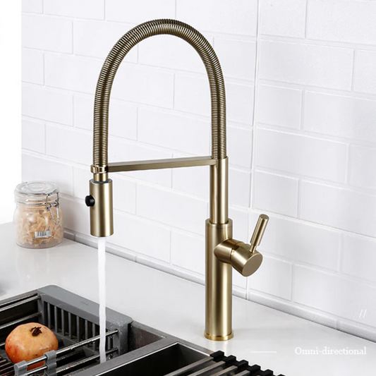 The Smesiteli Windsor Pull Out Spout Kitchen Faucet, made of solid brass with a flexible coiled neck and single lever, is shown over a sink with a white subway tile backsplash and a jar of pasta in the background.