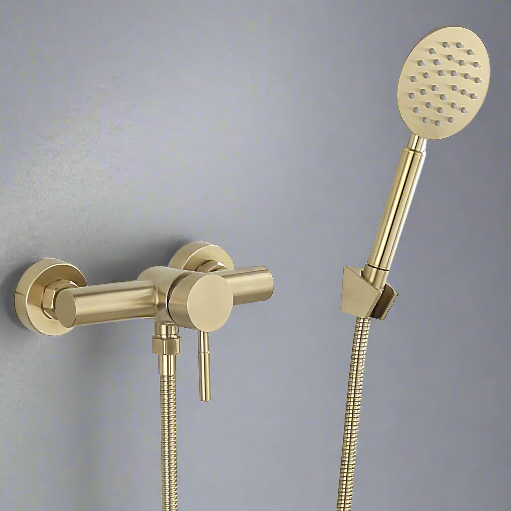 The AllFixture Wall Mounted Shower Faucet With Handheld in gold features a solid brass finish, a handheld shower head, and flexible hose, shown against a plain gray wall.