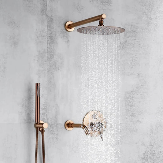 The Windsor Rose Gold Complete Shower System by Morsale.com features a round rose gold rainfall showerhead, matching gold control handle, and sleek handheld attachment, all mounted on a modern gray tiled bathroom wall.