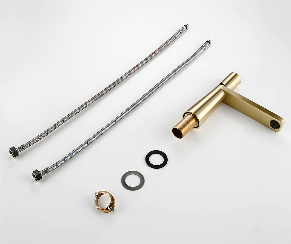 A close-up view of the contemporary Wasser™ Solid Brass Single Handle Bathroom Sink Faucet from Morsale.com, showcasing its sleek cylindrical handle. The handle has two small dots: one blue for cold water and one red for hot water. The background features a light blue wall, with a white surface underneath the faucet.