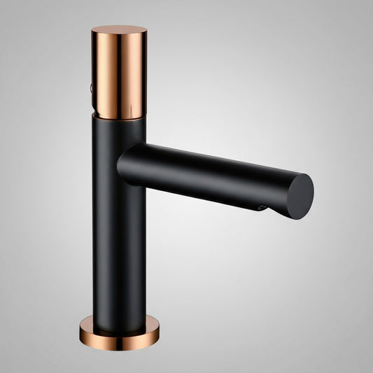 The Bagnolux Windsor Single Handle Bathroom Sink Faucet features a matte black cylindrical body and spout with shiny rose gold accents, plus a water-saving aerator—ideal for your bathroom sink—shown against a plain gray background.