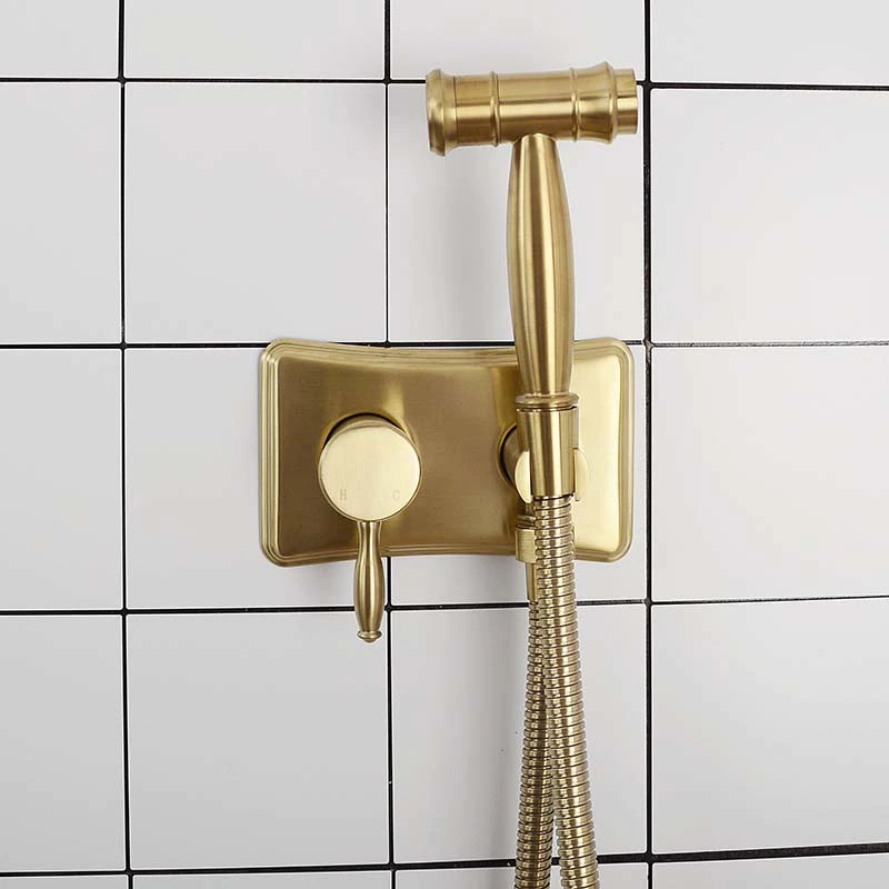 A hand holding the allfixture Wasser™ Solid Brass Hot & Cold Water Bidet Faucet with water flowing from the nozzle, reminiscent of a sleek shower head, against a dark background.