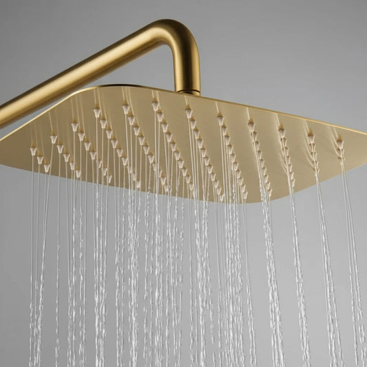 A close-up of the Mike Jake Shower Mixer & Bathtub Faucet Set features a gold square rain shower head with even water flow and a solid brass faucet, displayed against a plain gray background.