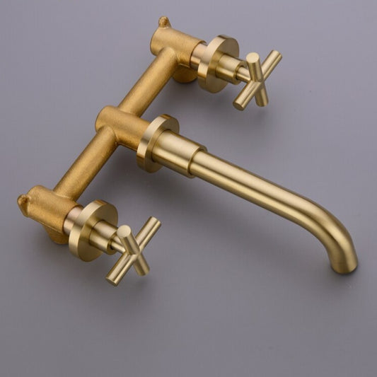 The Wasser™ Solid Brass Wall Mounted Bathroom Faucet from Morsale.com is a modern bathroom sink accessory with a matte gold finish. It features a sleek, curved spout and cross handles for hot and cold water. Clear water flows from the spout into the white sink below, adding an elegant touch to your bathroom decor.