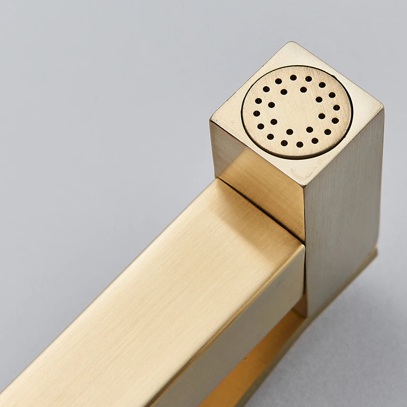 The Wall Mounted Brushed Gold Toilet Sprayer Bidet Faucet by Morsale.com, featuring a sleek minimalist design with a square nozzle head and flexible hose, seamlessly attaches to your wall. This modern sprayer perfectly complements contemporary bathroom faucets for a cohesive look.