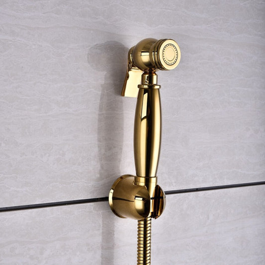 The AllFixture Windsor Wall Mounted Bidet Sprayer, featuring a matching gold holder and hose, is fixed to a light gray tiled bathroom wall to elevate hygiene and style.