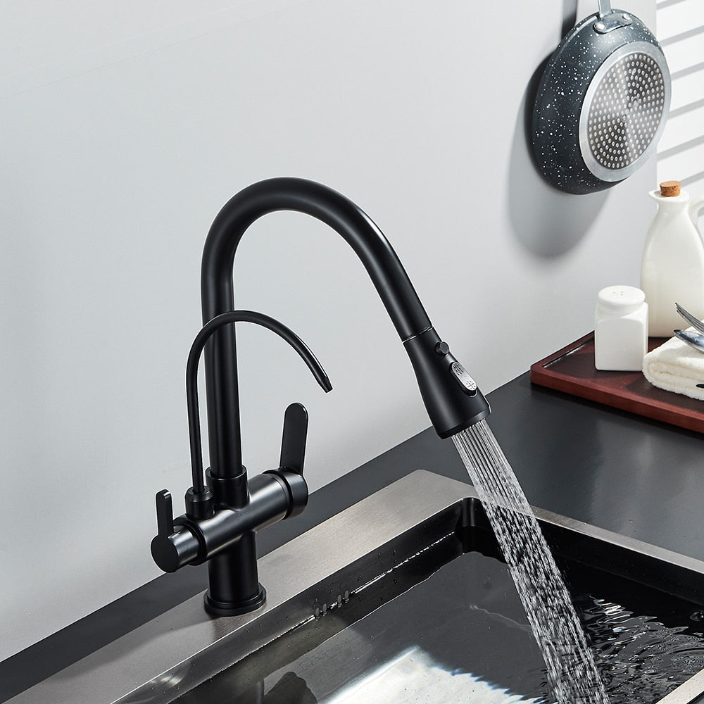 A person is turning on the Rozin Touch Sensor Brass Kitchen Faucet With Filtered Water Tap, which features a sleek, modern black design and a curved spout. Water flows smoothly into the sink below while kitchen items like a pan, soap dispenser, and bottles are visible on the counter in the background. This versatile faucet could easily complement any bathroom sink or shower setup.