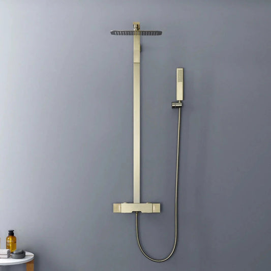 The Mike Jake Solid Brass Shower Set With Bathtub Faucet features a modern bathroom setup with a square rainfall showerhead mounted on the wall, releasing water. Completing the sleek look of the shower faucet, the set includes a handheld showerhead attached to a hose and wall bracket. The wall behind is painted in a soft gray color.