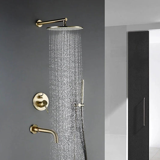 A modern bathroom featuring the Wasser™ Complete Shower System With Bathtub Filler in brushed gold from Morsale.com, which includes a large round overhead showerhead, a handheld showerhead, and a temperature control knob. A towel hangs on a wall hook next to a glass shower enclosure with wooden flooring, complemented by matching brushed gold hardware similar to those on kitchen faucets.
