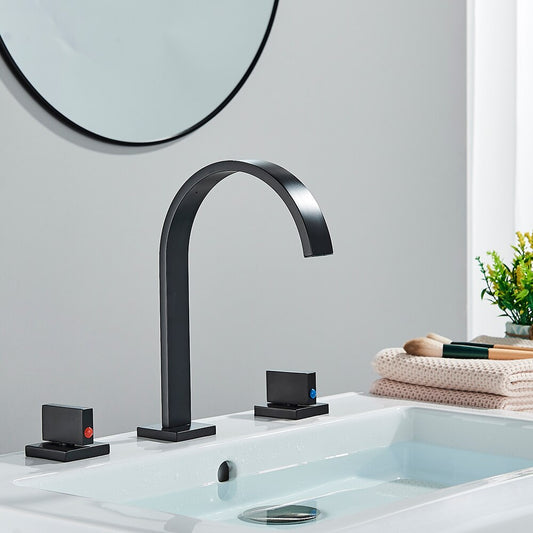 A minimalist black sink faucet from AllFixture, featuring an arching design, is mounted on a white countertop. The Double Handle Deck Mounted Faucet includes two lever handles—one on each side—with subtle red and blue indicators for hot and cold water respectively. In the background, a white window sill completes the scene.