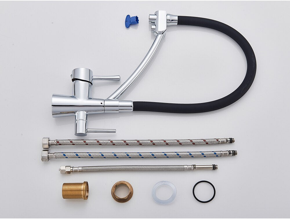 The Rozin Deck Mounted Kitchen Faucet with Purified Water Tap showcases a sleek brushed nickel finish and a high-arc, flexible black hose. Water flows gracefully from the spout into a stainless steel sink, set against a backdrop of light gray tiles and accompanied by a small, partially visible container.