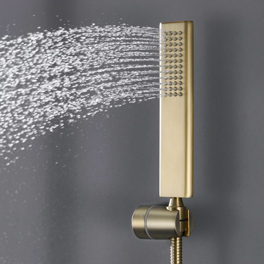 A Wall Mounted Shower Faucet With Handheld Shower Sprayer by Mike Jake is mounted on a light gray wall. It showcases a square overhead shower head, a handheld shower wand attached to a stainless steel hose, and boasts a minimalist design with a rectangular control valve. A bottle is visible on a shelf to the left of the sleek shower faucet.