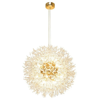 Two ornate Morsale.com Crystal Dandelion Sphere Ceiling Lights hang above a dining table, casting a warm glow over a minimalist room with beige walls, modern art, and a vase of greenery.