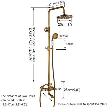 A wall-mounted Rozin Antique Brass Complete Shower Faucet Set with dual handles and white ceramic accents, labeled 'H' for hot and 'C' for cold. Water flows from the spout into a sink below, with flexible metal hoses connected to the faucet. The background is a gray tiled wall.