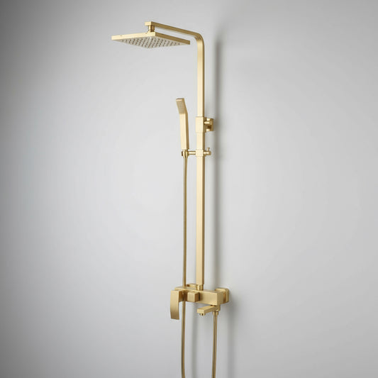 The Windsor Complete Shower System by Morsale.com includes a square rainfall shower head, handheld wand, and a wall-mounted control panel in brushed gold solid brass, shown against a plain light gray wall.