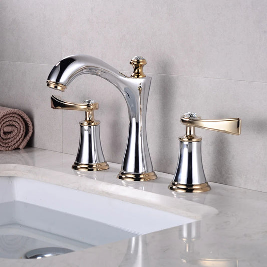 A bathroom sink setup featuring the Polished Gold & Chrome Bathroom Sink Faucet by AllFixture. This modern faucet includes two matching handles on either side and boasts a sleek design with a curved spout, all set against a shiny marble countertop, making it one of the most stylish options available. A folded towel is neatly placed in the background.