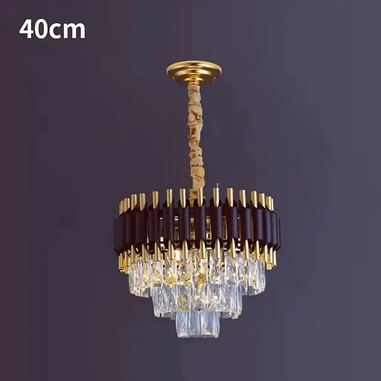Introducing the Morsale.com Verano Crystal Chandelier: a luxurious and modern centerpiece with a 40 cm diameter that exudes chic sophistication. Featuring a gold and dark brown frame adorned with tiered, rectangular crystal prisms, it elegantly reflects light to create an exquisite ambiance. The chandelier is suspended from a gold chain wrapped in beige fabric for added refinement.