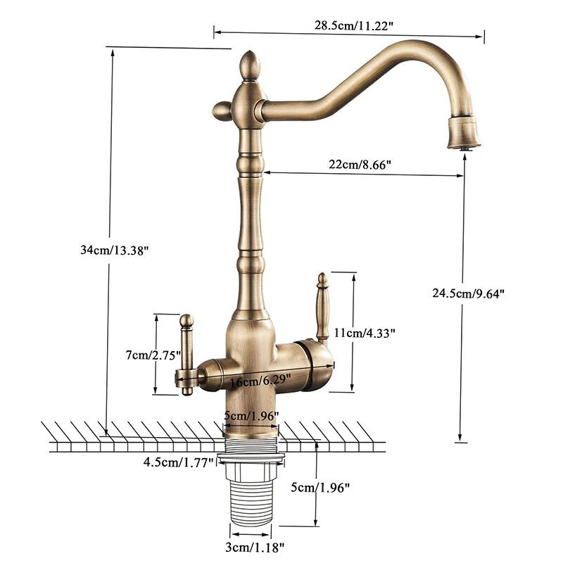 A sleek Uythner Dual Handle Solid Brass Faucet With Filtered Water Tap, featuring a vintage design, is mounted on a gray countertop. Water flows from the curved spout into a stainless steel sink below. In the background, a white bowl with a decorative pattern rests beside vegetables. Light filters through blinds, highlighting the elegant fixture.