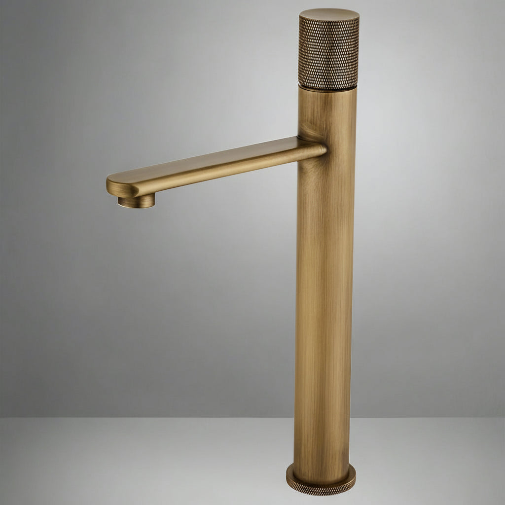 The AllFixture Maison Antique Brass Bathroom Faucet features a modern, tall cylindrical body, straight spout, and textured handle and base, all set against a neutral gray background.