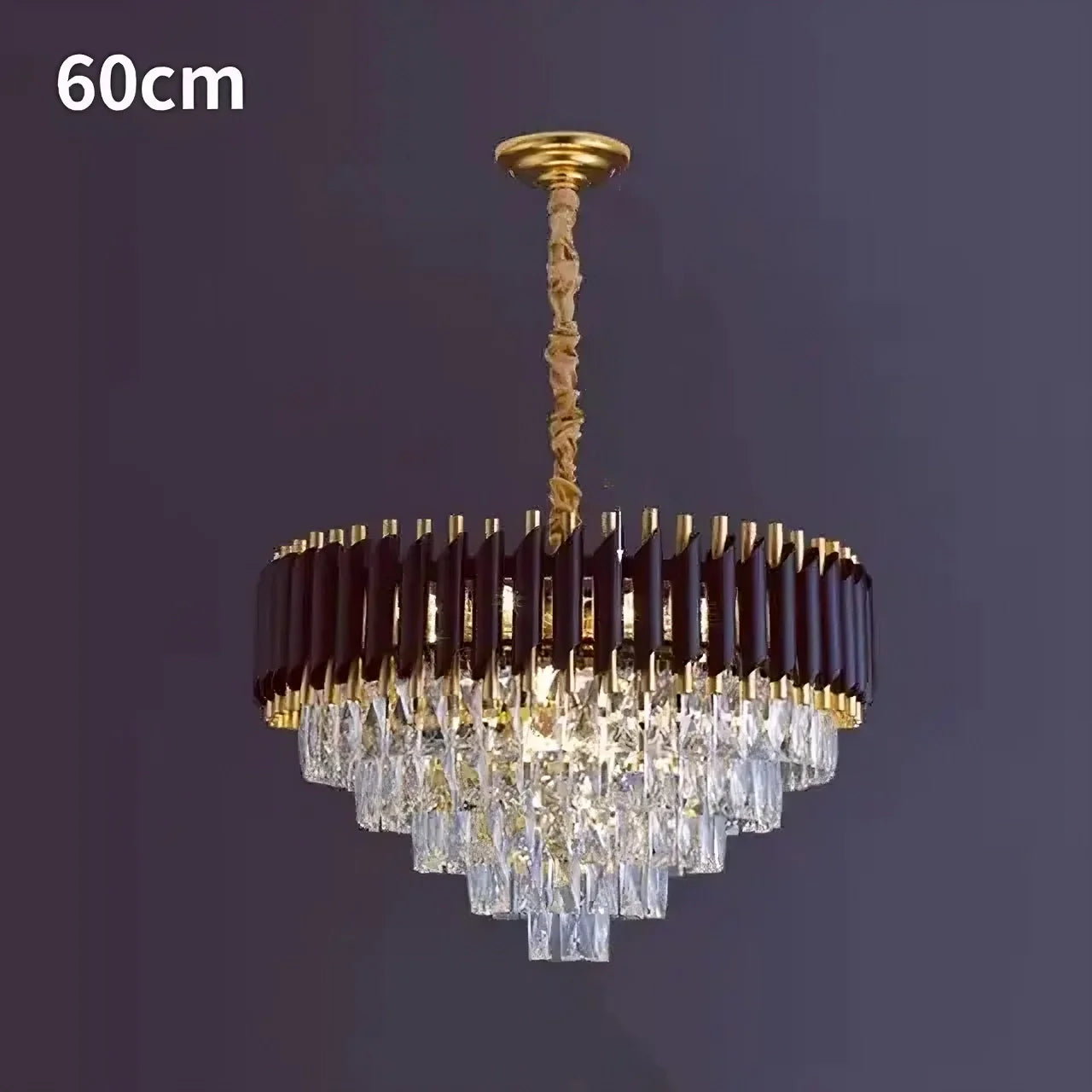 The Verano Crystal Chandelier by Morsale.com is a contemporary decorative lighting fixture featuring a 60cm diameter. Its chic sophistication is highlighted through a circular arrangement adorned with dark brown and gold accents. Multiple tiers of clear crystal prisms hang in an elegant pyramid shape, enhancing its luxurious appearance when set against a dark background.