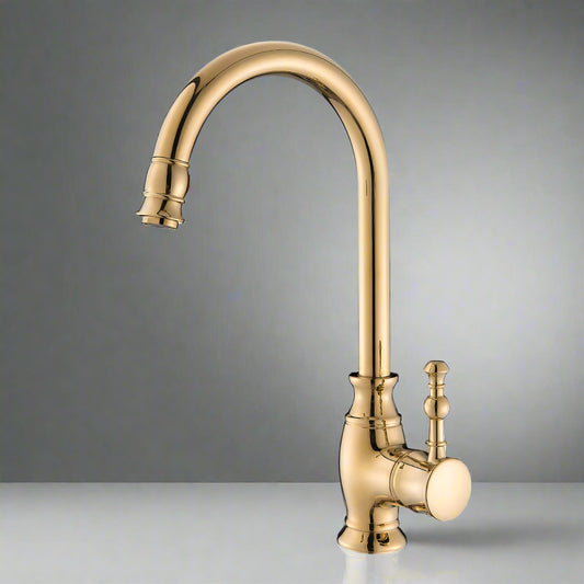 The Tiqui Polished Gold Single Handle Kitchen Faucet, featuring a high curved spout and side lever handle, rests on a reflective surface against a plain gray background, showcasing the elegance of modern kitchen fixtures.