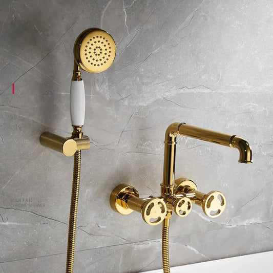 A Wanfan Wasser™ Antique Wall Mounted Bathtub Spout with Hand Shower, featuring a luxurious gold-colored finish, is set against a gray marbled wall. The design includes a handheld shower head with a white handle, an adjustable wall mount, and a gold faucet with two control knobs. Its sleek metallic finish perfectly complements your bathroom sink faucet to add a touch of luxury.