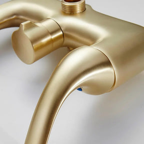 Image of the Tiqui Complete Shower Set With Bathtub Faucet showcasing a luxurious round overhead rain showerhead, a handheld sprayer, and dual-handle controls. Close-up views highlight the detailed craftsmanship of the showerhead, handheld sprayer, and control handles, all in a matte gold finish.