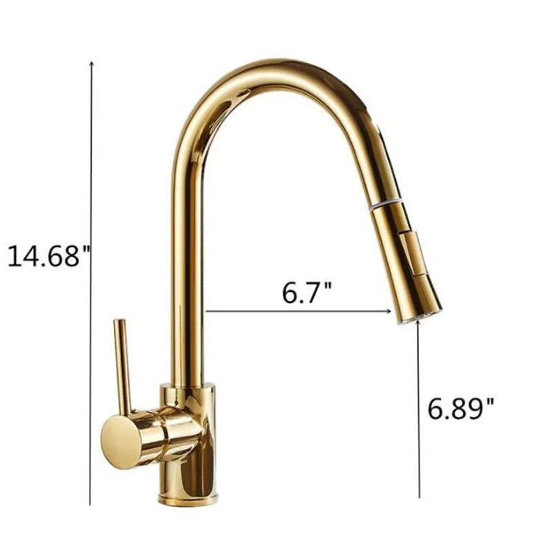 A hand holding the detachable spray head of Tiqui's Single Handle Pull Out Kitchen Faucet, directing the water stream into a stainless steel sink. The sleek, gold-colored faucet features a single lever handle for controlling water flow and temperature. The background shows a marble-like wall.