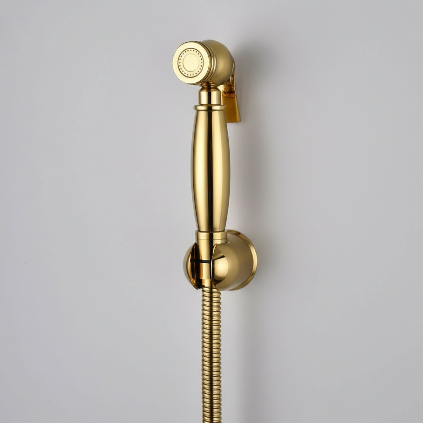 The AllFixture Windsor Wall Mounted Bidet Sprayer in gold, with a matching mount and flexible hose, is attached to a light gray wall—ideal for enhancing your bathroom hygiene.