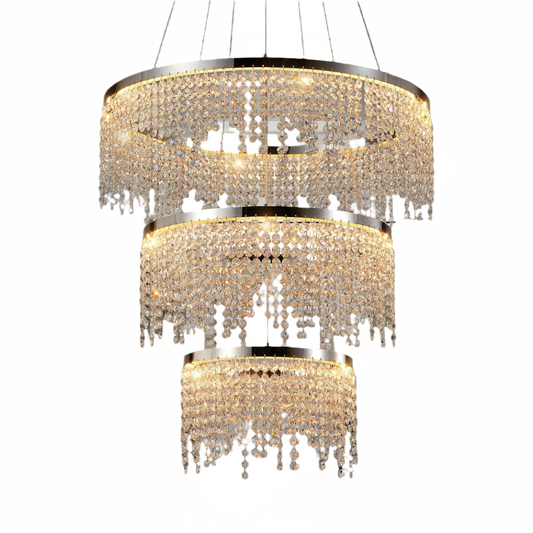 The Morsale Alleri 3-Tier Crystal Chandelier features shimmering crystal strands on a sleek stainless steel frame, emitting a warm glow. This luxurious piece blends classic elegance with a contemporary style, enhancing any space with its intricate and opulent design.