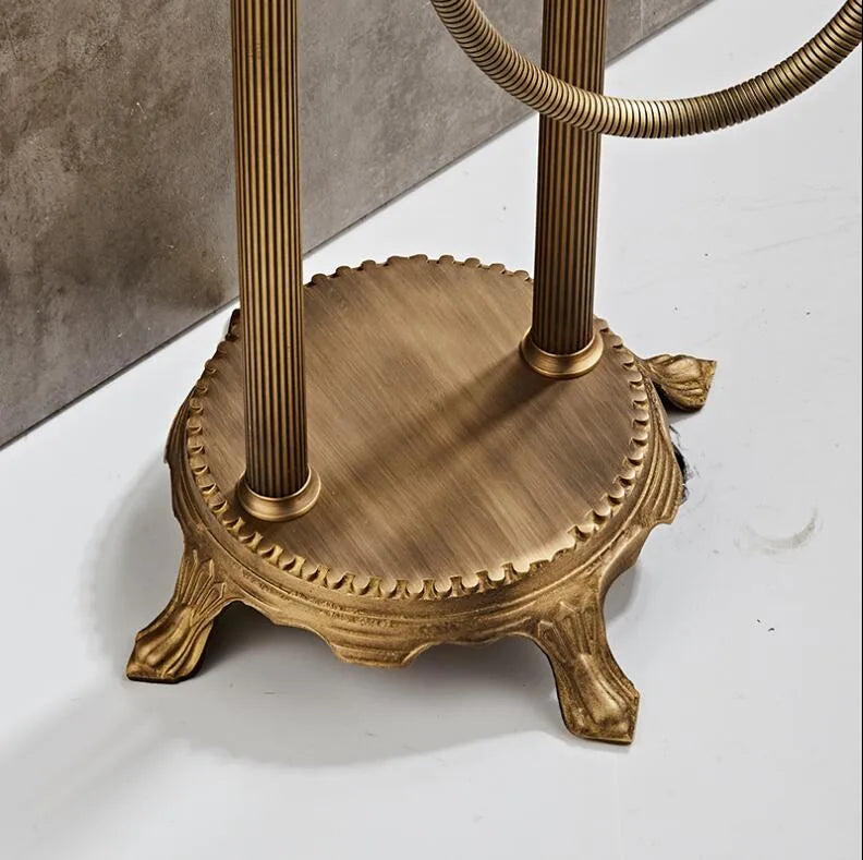 Heritage Floor-Mounted Bathtub Filler & Hand Shower Faucet base with antique brass finish and decorative feet.