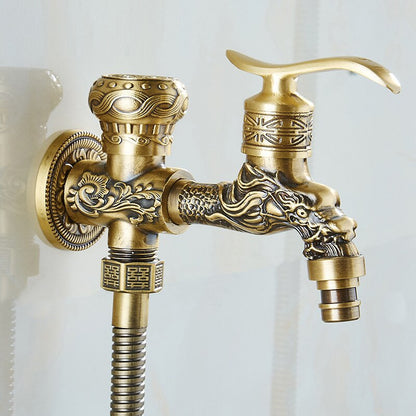 A decorative Wall Mounted Antique Bronze Toilet Sprayer Bidet Faucet from Tiqui set against a light background. The set includes an intricately designed faucet handle, a water spout with ornate detailing, and an adjustable handheld sprayer attached to a flexible hose. The design features floral and geometric patterns.