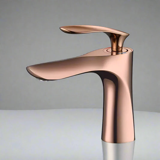 The Allfixture Rose Gold Bathroom Faucet – Deck-Mounted Basin Mixer features a sleek, curved design and single handle, standing on a white surface with a gray background, adding modern elegance to any bathroom.