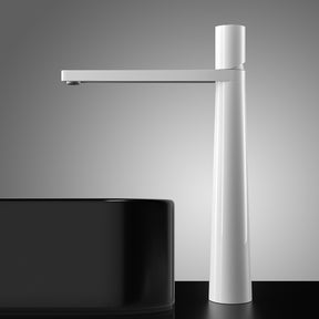 An AllFixture Solid Brass Single Handle Bathroom Basin Faucet with a modern gold finish and sleek, straight design is installed on a white countertop. The faucet is turned on, releasing a gentle stream of water into the white basin sink, creating small bubbles. The background features light gray and white decor.