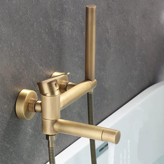 The AllFixture Maison Bathtub Faucet With Shower Head, in brushed antique gold, features a wall-mounted design with a single lever and matching hand shower above a white tub on a dark gray wall.
