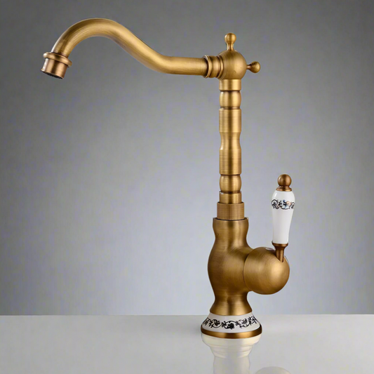 The Allfixture Tall Torneiras Bathroom Faucet features a single handle, hot and cold water mixer, tall curved spout, and decorative black floral accents on the white handle and base, shown standing on a reflective surface against a gray background.