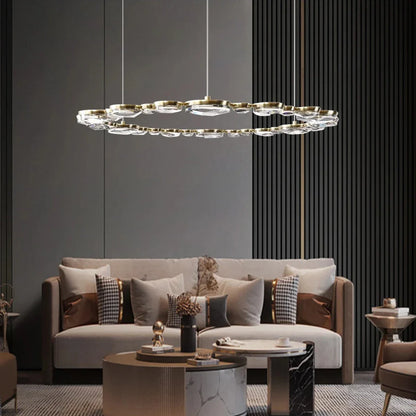 The modern living room features a Morsale Diamante Crystal Ceiling Light Fixture, a gray sofa with patterned cushions, and round coffee tables. The neutral color palette and textured walls create an elegant, contemporary ambiance.