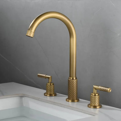 A modern bathroom sink with the Tiqui™ Solid Brass Bathroom Sink Faucet by Mike Jake, featuring a tall arched spout with running water. The faucet has textured handles for hot and cold water on either side. The rectangular sink is set into a marble countertop against a gray wall.