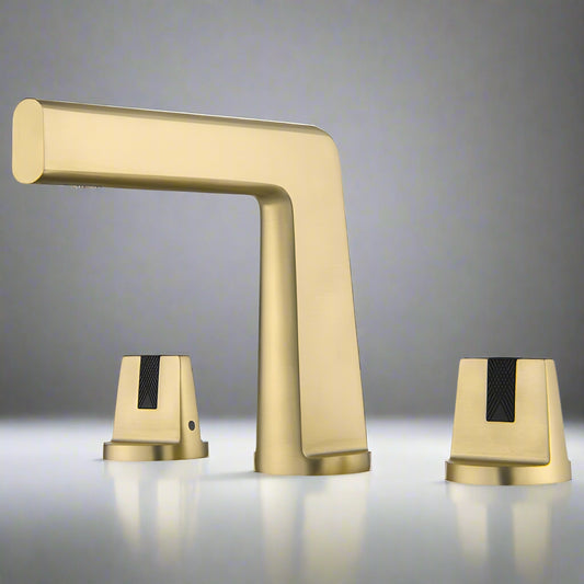 The Tiqui Solid Brass Dual Handle Bathroom Faucet features a modern geometric design in matte gold with black textured grips, and is basin mounted, shown here against a neutral gray background.