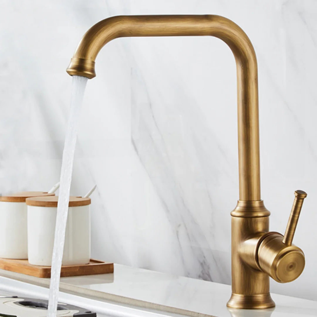 The Maison Single Handle Bathroom Sink Faucet by AllFixture, featuring a right-side lever, pours water into a sink. Nearby, two white canisters with wooden lids rest on the counter in front of a marble backsplash.