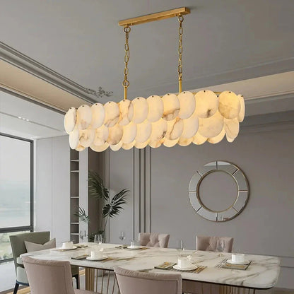 Moonshade Marble Dining Room Chandelier with natural Spanish marble and brass construction, illuminating a modern dining space.