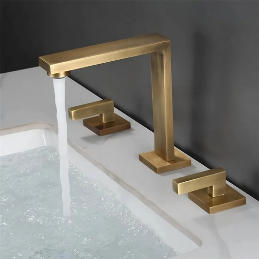 The Tiqui Dual Handle Brass Bathroom Sink Faucet, featuring a modern brushed brass finish and a sleek square design, is mounted on a white countertop. Water flows from the central spout into the filled sink against a dark gray wall, exemplifying elegance in bathroom faucets.